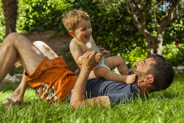 Erkek bebek ve arka bahçe köpek oynamaya baba. Yaz Zamanı