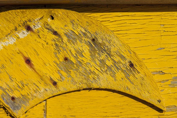 Rusty yellow painted broken wood texture. Close up. Copy space