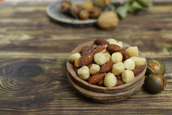Roasted salted nuts mix, snack from macadamia, walnotes and almonds and unshelled nuts