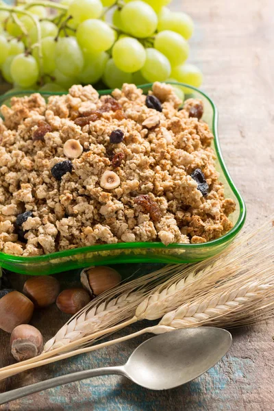 Desayuno saludable de granola muesli con uva, nueces y espigas de trigo — Foto de Stock