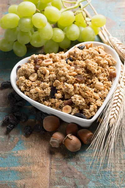 Desayuno saludable de granola muesli con uva, nueces y espigas de trigo — Foto de Stock