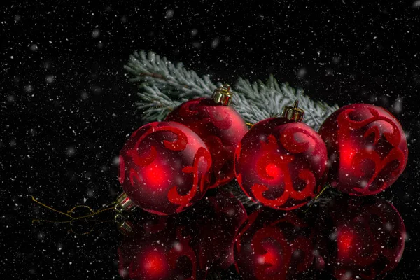 Red christmas tree decoration, red balls and green fir on black — Stock Photo, Image