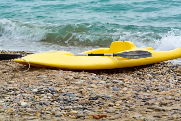 Water sport equipment - kayak on the beach, nobody