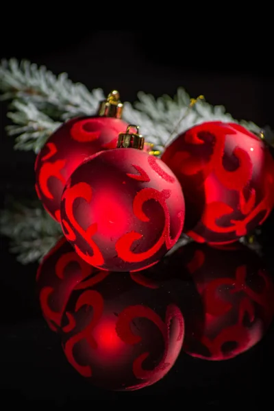 Red christmas tree decoration, red balls and green fir on black — Stock Photo, Image