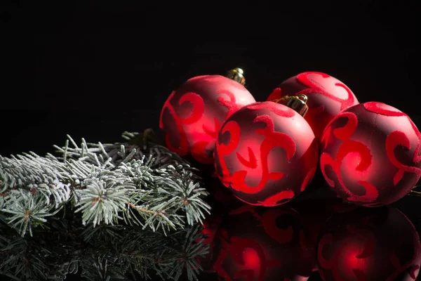 Red christmas tree decoration, red balls and green fir on black — Stock Photo, Image