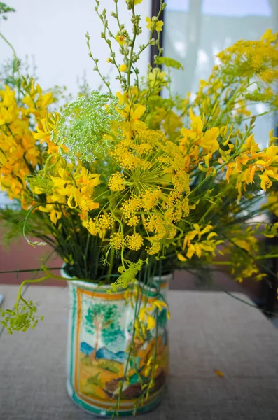 Bouquet with wild yellow flowers and wild fennel