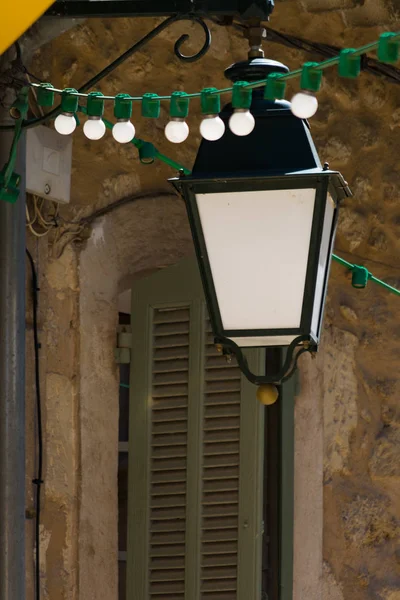 French style old vintage iron with glass street light in small village in Provence, France