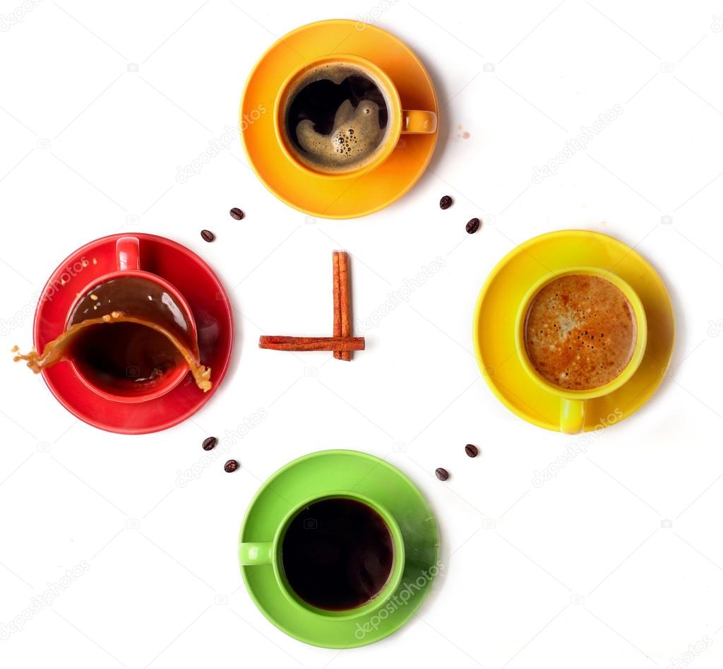 Cups with coffee, stacked in a circle. Clock consist of four cups.Cinamon sticks lancets Time. Alarm clock. Splash coffee .White background