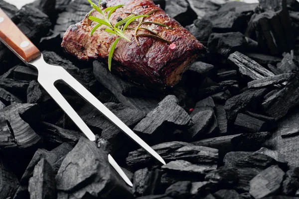 Beef steak on the charcoal with meat fork.product photo, place for your advertisment — Φωτογραφία Αρχείου