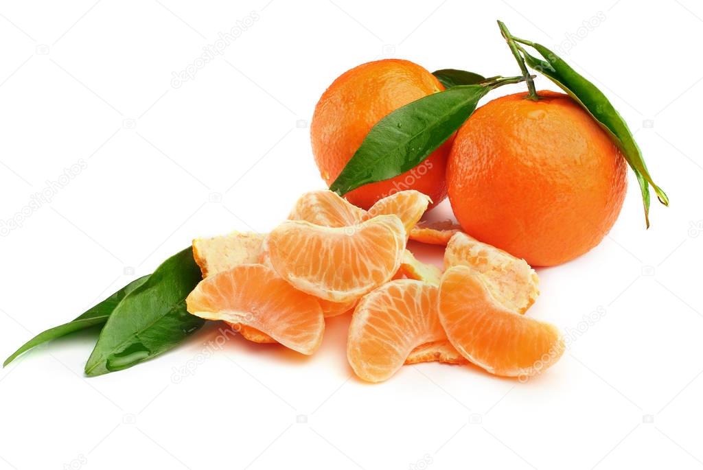 Two tangerines with leaves and slices on white background