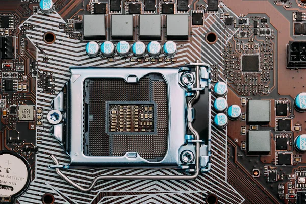 Empty cpu processor socket on a computer motherboard with pins visible. Blue toned. — Stock Photo, Image