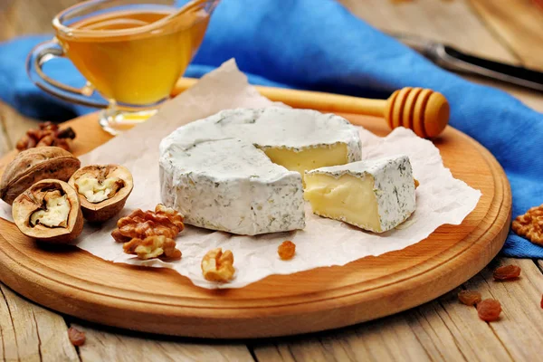 Camembert och brie ost på trä bakgrund med nötter kryddor och honung. Italiensk mat. — Stockfoto