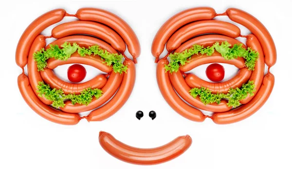 Happy smiling face from food- sausages, lashes salad, pupil mini pumkin.Concept funny food.Food art.Food emotion — Stock Photo, Image