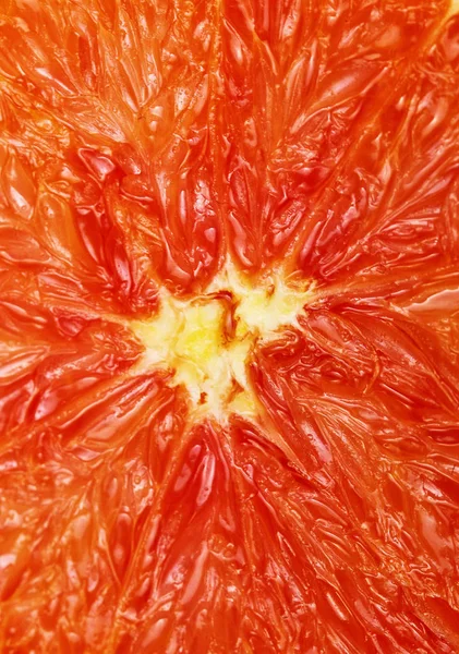 Tło z owoców cytrusowych plastry grejpfruta. Szczelnie-do góry. Studio fotografii. Makro — Zdjęcie stockowe