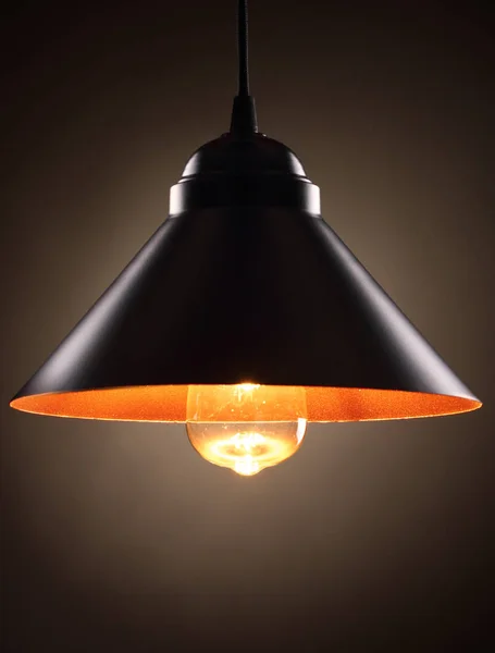 Industrial pendant lamps against wall. Loft interior. Edison bulbs.