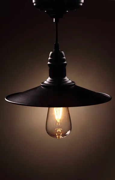 Industrial pendant lamps against wall. Loft interior. Edison bulbs.