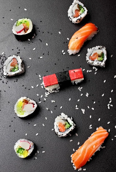 Different sushi and rolls with seafood. On the stone table. — Stock Photo, Image