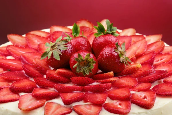 Strawberry cake with vanilla cream.Red background.Closeup