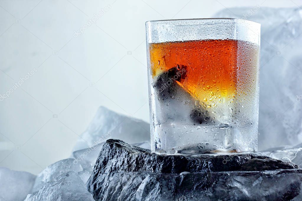 Glass of whiskey. On the iceberg, ice everywhere.Creative photo of alcohol.Advertisng shot.Copy space.Whiskey wedge