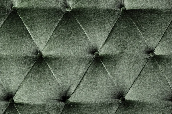 Green cloth sofa texture background.Concept of closeup upholstery. velvet