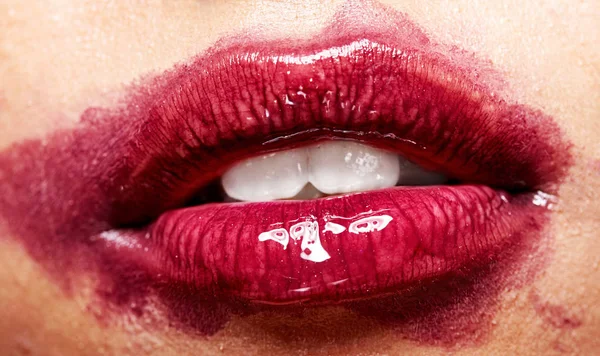 Sexy lippen met de vlekkerig lippenstift. Open mond met witte tanden. Cosmetologie, drogisterij of mode make-up concept. Beauty studio opname. Closeup — Stockfoto
