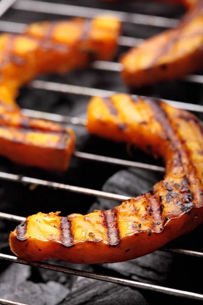 Calabaza asada en una rejilla sobre fondo de carboncio.Calabaza barbacoa . —  Fotos de Stock