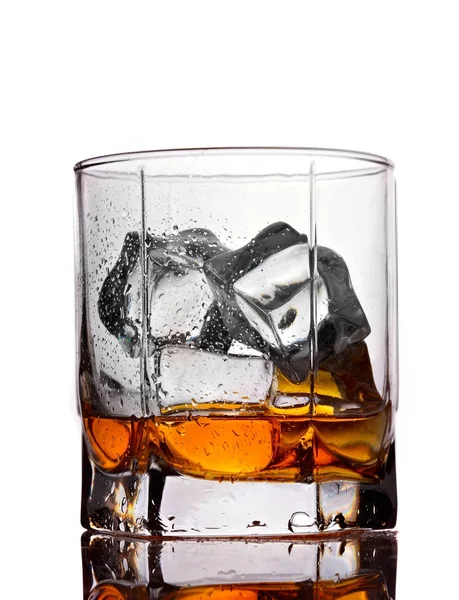 Half empty glass of whiskey with ice isolated on white background — Stock Photo, Image