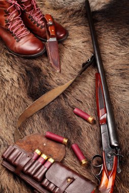 Çift namlu vintage av tüfeği, avcılar bıçak, palaska deri ve deri çizme mmunition, yaban domuzu kürk üzerinde avcılık yakın çekim. Uzay kopyalayın. Kavram avcılık