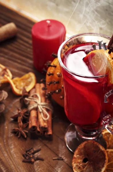 Glass of christmas hot mulled wine on wooden table with species and oranges against wooden table.Copy space — Stock Photo, Image