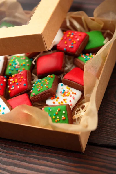 Open box Christmas different colour cookies on a old wooden table.Copy space