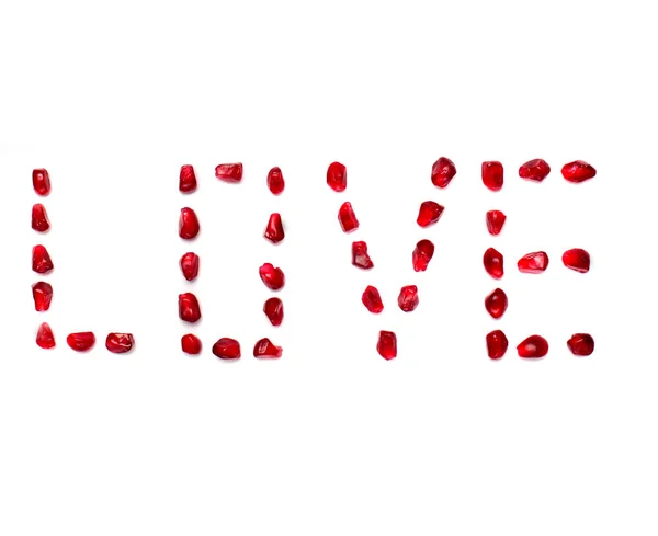 Inscription love of pomegranate grains on white white background.Concept love, valentine's day.Font — Stock Photo, Image