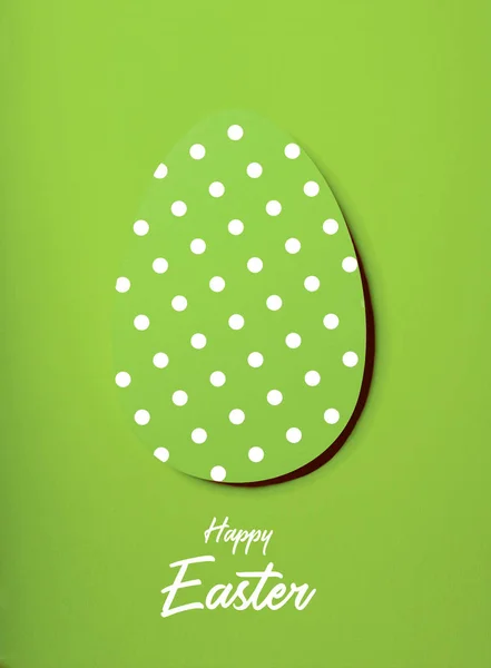 Easter greeting card with green paper eggs with dots .Creative greeting concept. Inscription happy easter.Layout with copy space for your text