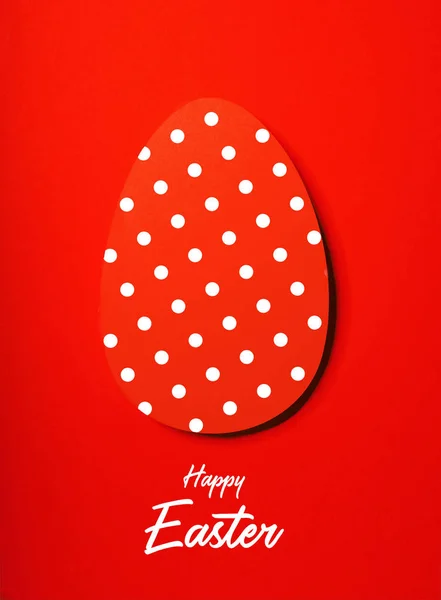 Easter greeting card with red paper eggs with dots .Creative greeting concept. Inscription happy easter.Layout with copy space for your text