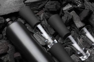 Mat şişe alkol ve atış gözlük siyah kümesi. Kömür arka plan üzerinde. Siyah baskı. Yaratıcı. içelim. Cheers.Mockup.Creative arka cam ve kömür