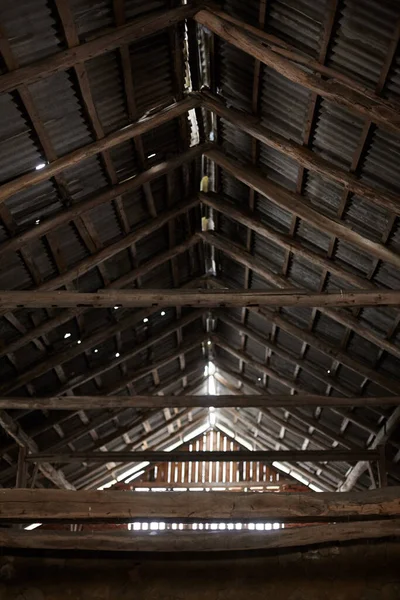 Old roof trusses covered with ceramic tile on a detached house under construction, visible roof elements, battens, counter battens, rafters. Roof system with wooden timber, beams