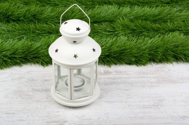 Christmas decoration with lantern on white wooden background