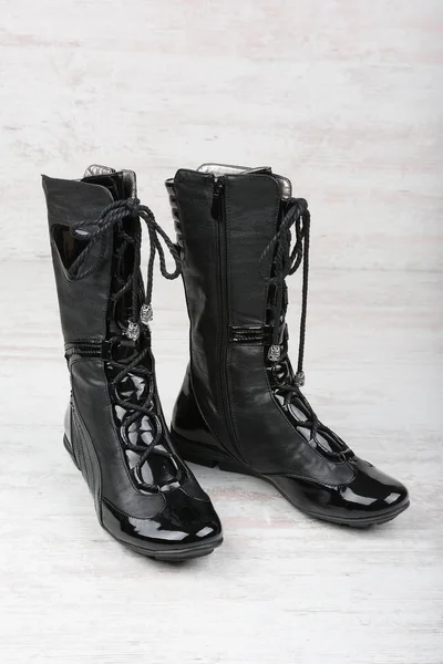 Ženské černé vysoké boty na bílém pozadí dřevěná — Stock fotografie