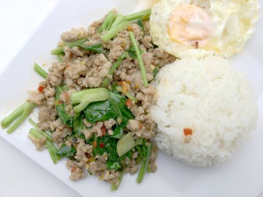 Yakından heyecan ile tepesinde pirinç kızarmış kıyılmış domuz eti ve fesleğen, Tayland gıda.