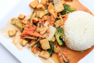 Kızarmış Tofu karışık sebze ve et suyu sosu ile beyaz arka plan üzerinde beyaz tabak ilave edin. Vejetaryen yiyecekler, sağlıklı gıda.