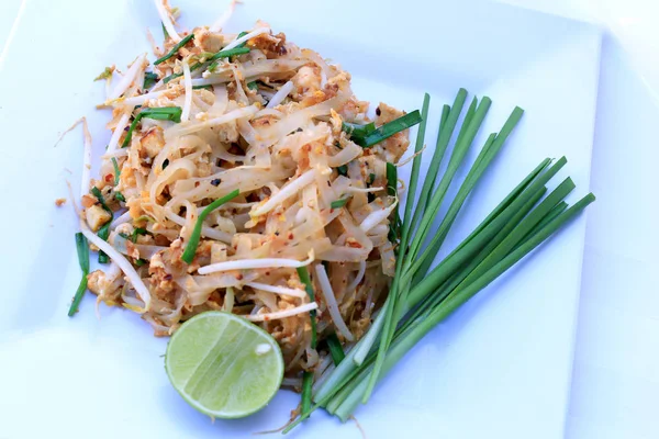 Pad Thai, stir-fried rice noodles with shrimp in white dish isolated on white background. The one of Thailand\'s national main dish. the popular food. Thai Fried Noodles