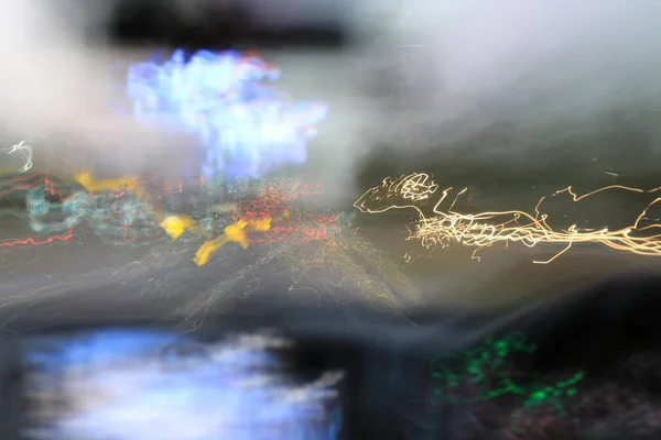 从车内看到的夜路自然光街道和其他车辆的运动模糊了，从车内看到的模糊图像在夜间行驶. — 图库照片