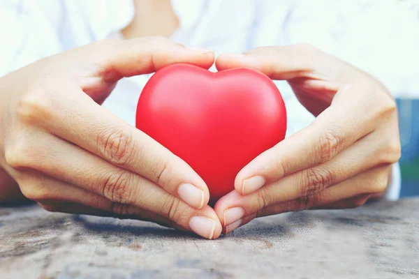 Female hands giving red heart. vintage tone — Stock Photo, Image