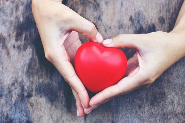 Female hands giving red heart. vintage tone — Stock Photo, Image