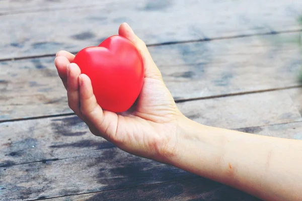 Female hands giving red heart. vintage tone — Stock Photo, Image