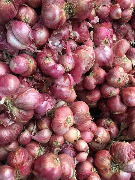 Red onions in plenty on display at local farmer\'s Thailand Market. Big Red Onions Background, Eleutherine bulbosa vegetable thai food.