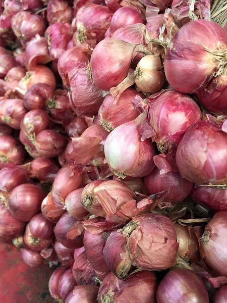 Red onions in plenty on display at local farmer\'s Thailand Market. Big Red Onions Background, Eleutherine bulbosa vegetable thai food.