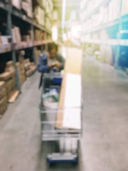 Blurred image of people shopping in at hardware store or storehouse with variety of indoor & outdoor ceiling fans, flushmount,recessed,track lights, led. vintage tone with light effect. — Stock Photo, Image