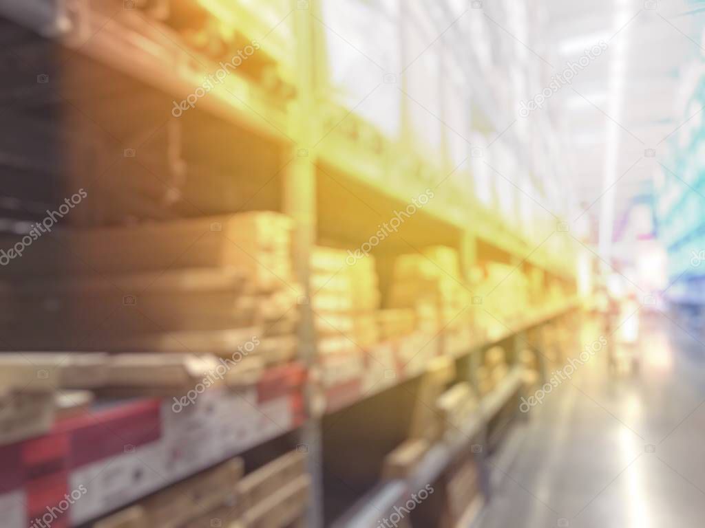 blurred image of people shopping in at hardware store or storehouse with variety of indoor & outdoor ceiling fans, flushmount,recessed,track lights, led. vintage tone with light effect.