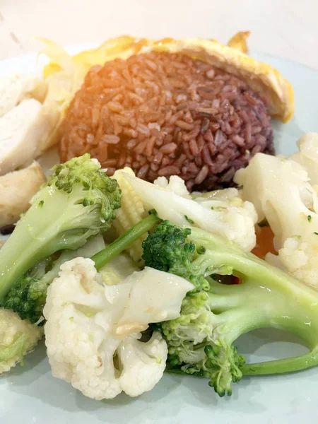 Temiz gıda, Riceberry pirinç haşlanmış tavuk, havuç ile ile diğer vegetableand freied yumurta tometo. Kantin veya gıda mahkeme arka plan bulanıklık ile beyaz tabak içinde sağlık için iyi.
