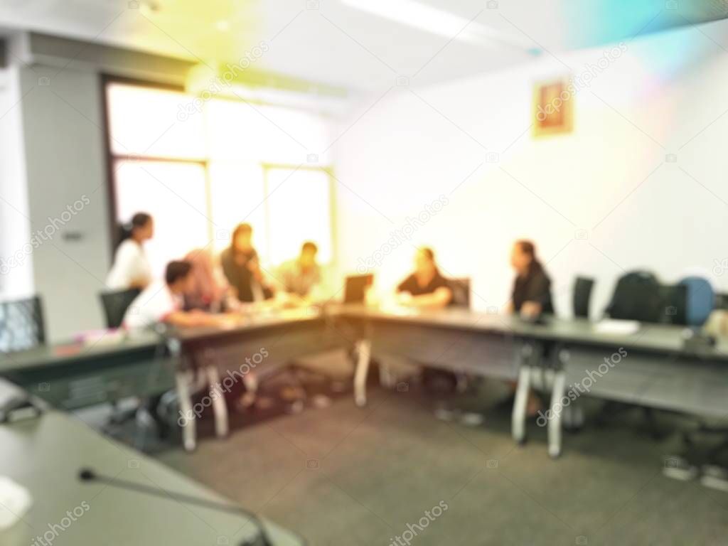 Education concept, Abstract blurred background image of students and business people  studying and discuss in large hall profession seminar with screen and projector for showing information.